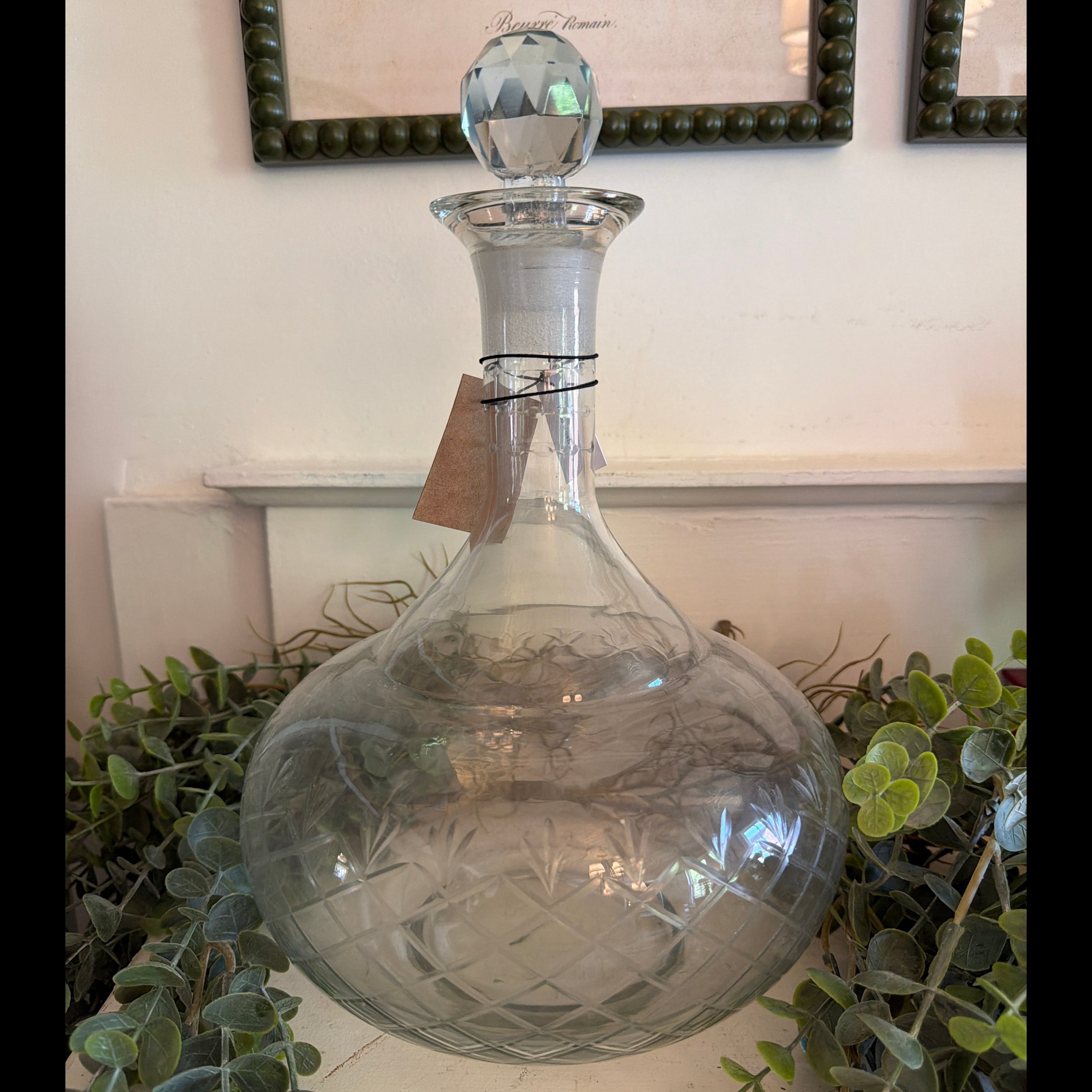 Clear Recycled Etched Glass Decanter w/ Glass Stopper, 3 Quart, with intricate etched pattern, displayed among greenery for elegant kitchen and dining decor by Knotty and Board.