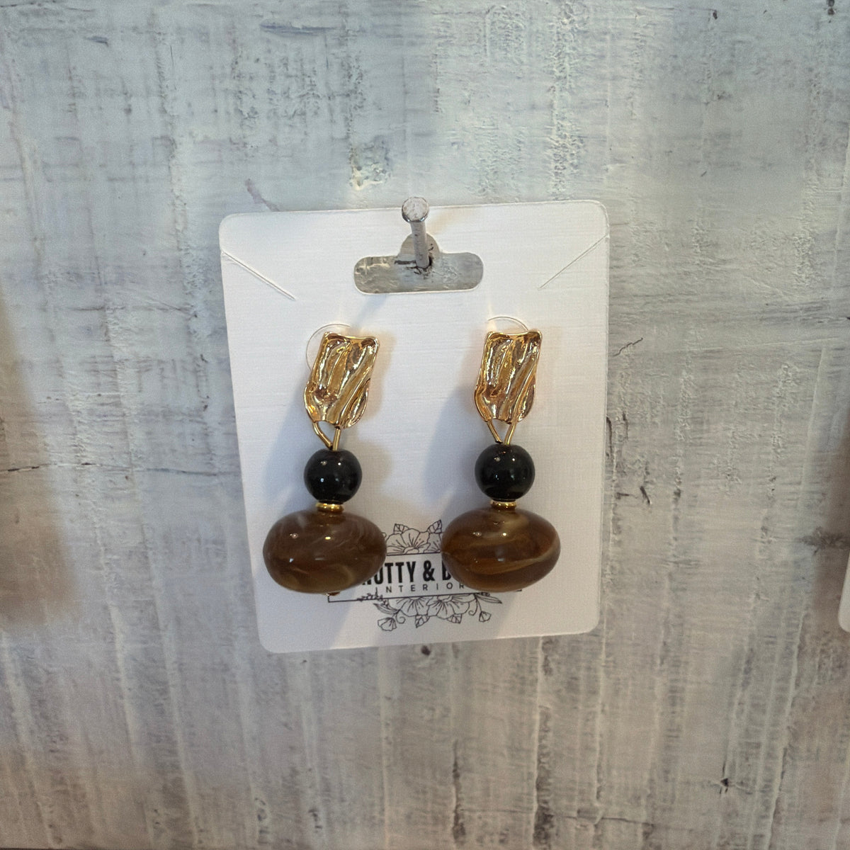 Vintage Swirl Amber Stud Earrings featuring amber-toned swirled beads with black accents and gold textured studs, perfect jewelry gifts for decor lovers from Knotty and Board.