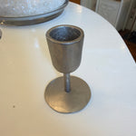 Single silver cast iron taper candle holder with a minimalist design on a white surface, perfect for decor, gifts, and dining ambiance. Cast Iron Taper Candle Holder, Silver, 2 X 2.5 in. 1
