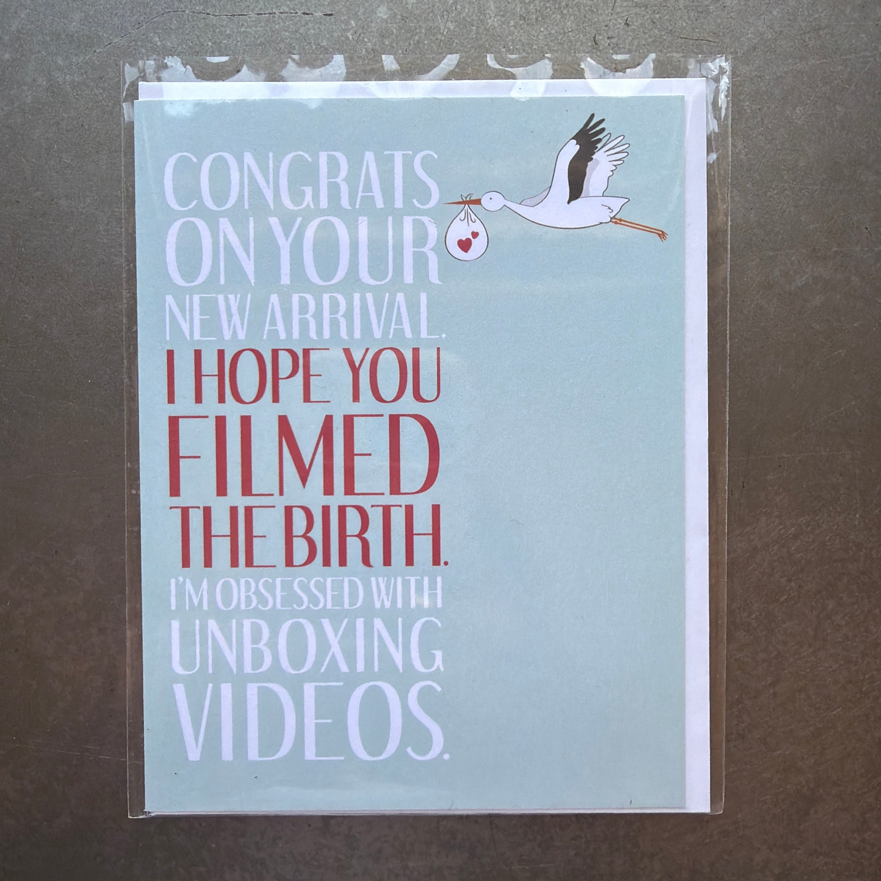 Unboxing Funny New Baby Card with a stork illustration and humorous text congratulating on a new arrival, perfect for gifts, decor, and entertaining from Knotty and Board.