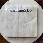Lunch Napkin, 20 Ct, Unikko White Grey Marimekko featuring subtle white and grey floral pattern packaging on a marble surface, perfect for kitchen decor and entertaining. 1