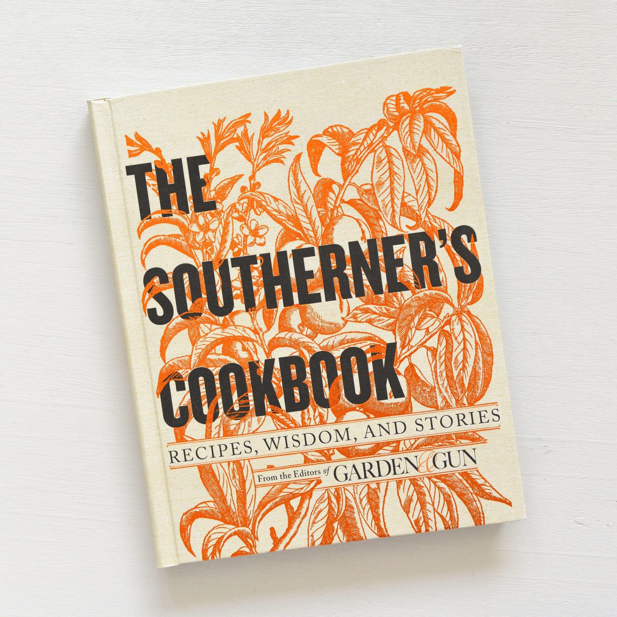 The Southerner's Cookbook with orange botanical illustrations on a cream cover, featuring recipes, wisdom, and stories, perfect decor and gift from Knotty and Board.