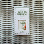 Pura Refill, Fir & Grapefruit fragrance refill in a white box with green and orange accents, displayed on woven wicker surface, ideal for Knotty and Board decor and gifts. 1