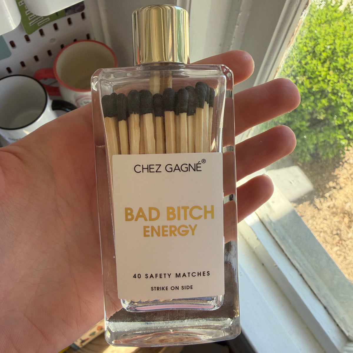 Clear rectangular match container with black-tipped wooden matches labeled 