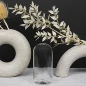 Everlasting Candles Vase, Wylie Clear glass vase displayed between two modern white ceramic decorative rings, ideal for stylish home decor and gifts from Knotty and Board.