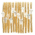 Multiple gold stretch bead & shell cross bracelets, 4mm, stacked together with a polished finish, perfect gifts for stylish jewelry and decor lovers from Knotty and Board. 2