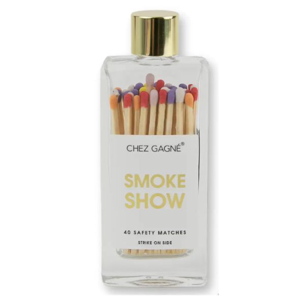 A clear glass bottle filled with colorful wooden matches with multi-colored tips and a gold cap, labeled "SMOKE SHOW", perfect for stylish decor and gifts in the kitchen or dining area, Matches, Multi, Smokeshow.