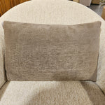 Beige textured rectangular pillow on a cream fabric chair, showcasing the Designer Pillow Line Lucky Moleskin for stylish home decor and cozy comfort from Knotty and Board. 1