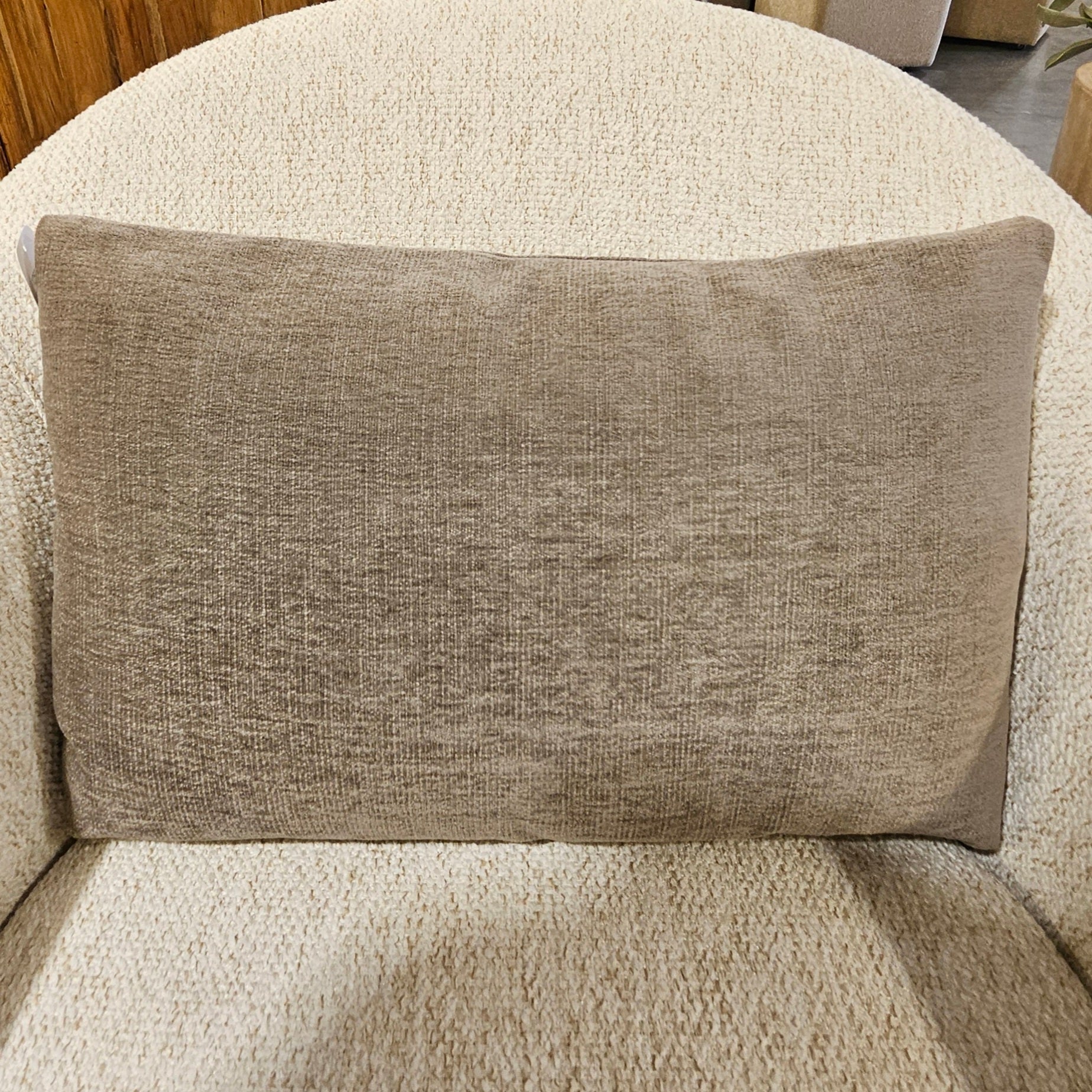Beige textured rectangular pillow on a cream fabric chair, showcasing the Designer Pillow Line Lucky Moleskin for stylish home decor and cozy comfort from Knotty and Board.