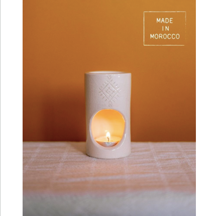 Mer-Sea Ceramic Scented Oil Burner in white ceramic with Moroccan-inspired design lit by a small candle, perfect for enhancing home décor and gifting from Knotty and Board.