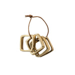 Square Gold Napkin Rings, Set of 4 displayed on a rustic brown string, perfect for adding elegant decor to kitchen or dining settings from Knotty and Board. Every Room Needs A Little Knotty and Board. 1