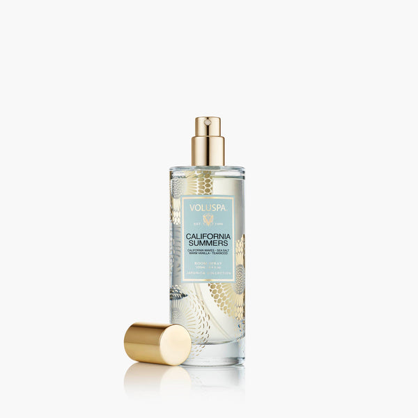 Voluspa California Summer Room Spray in a clear glass bottle with gold detailing and cap, perfect for adding a fresh, inviting scent to your home decor from Knotty and Board.