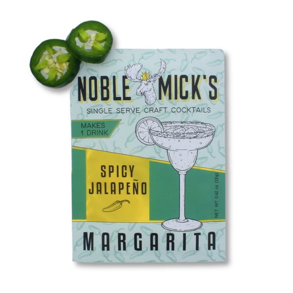 Noble Mick's Single Serve Craft Cocktail, Spicy Jalapeno Margarita packet next to two sliced fresh jalapenos, perfect for kitchen entertaining and gifts from Knotty and Board.