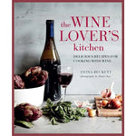Cookbook cover titled Wine Lover's Kitchen featuring a bottle of red wine, a glass of wine, fresh artichokes, garlic, and herbs on a rustic kitchen surface, emphasizing kitchen decor and gifts. 1