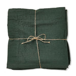 Slub Cotton Everyday Napkins, Set of Four, Dark Green neatly folded and tied with natural twine, perfect for adding cozy decor to kitchen and dining spaces with Knotty and Board style. 1