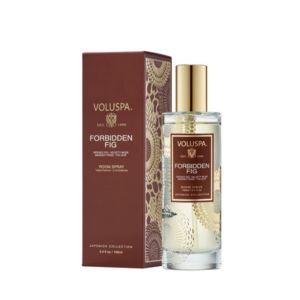 Voluspa Forbiden Fig Room Spray, 3.4 oz. in an elegant glass bottle with gold cap, displayed next to its intricate brown and gold decorative box, perfect for home decor and gifts from Knotty and Board.