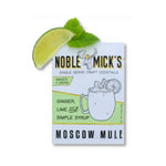 Noble Mick's Single Serve Craft Cocktail, Moscow Mule packaging beside a fresh lime wedge and mint leaf, perfect for entertaining and gifts from Knotty and Board. 1