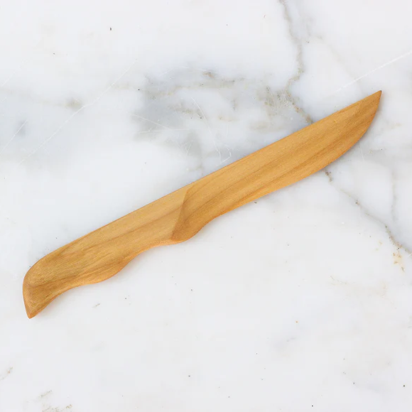 Cherrywood Knife handcrafted from smooth cherrywood, ideal for kitchen use and stylish dining, offered by Knotty and Board with curated decor and gifts.