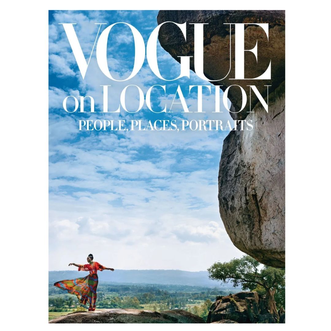 Cover of Vogue on Location magazine showing a person in colorful clothing dancing outdoors near a large rock formation with a scenic landscape and blue sky in the background, perfect for decor inspiration and gifts from Knotty and Board.