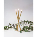 Three burning Everlasting Candles Gold, Candles Only, Set of 3 arranged in a clear round vase with green eucalyptus leaves, elegant decor for kitchen or dining by Knotty and Board. 1