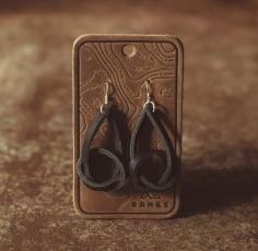 Knot Earrings, Black displayed on a decorative card, featuring elegant black looped design suitable for stylish gifts and jewelry collections from Knotty and Board.