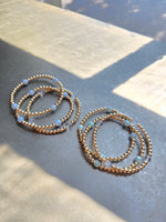 Morgan & Me 4mm 14k Gold Filled Bracelet with Asst Gemstones displayed on a smooth surface with natural light, perfect for gifts and jewelry enthusiasts at Knotty and Board. 1