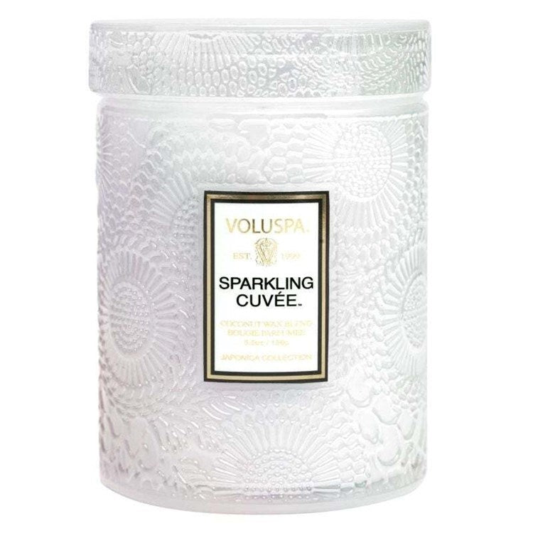 Voluspa Sparkling Cuvee Small Jar Candle, 5.5 oz with textured white jar featuring floral patterns, perfect for adding elegant decor and cozy ambiance to any room from Knotty and Board.