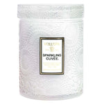 Voluspa Sparkling Cuvee Small Jar Candle, 5.5 oz with textured white jar featuring floral patterns, perfect for adding elegant decor and cozy ambiance to any room from Knotty and Board. 2