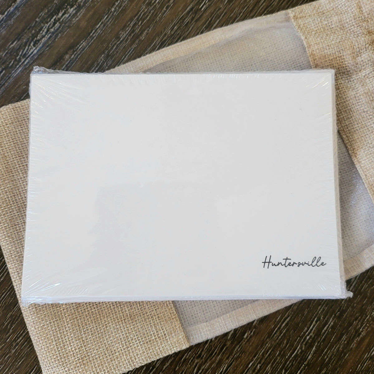 Note Card Set Pack of 10 - Huntersville featuring simple elegant design on white cards, perfect for gifts and home decor from Knotty and Board, displayed on textured fabric.