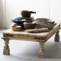 Rustic wooden table with carved legs displaying various wooden bowls and trays, styled as Primitive Bajot, found, varies, perfect for home decor and gifts from Knotty and Board.