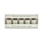 Bourbon Barrel Foods Woodford Bitters Dram Set featuring five small glass bottles of bourbon barrel aged bitters in a white branded box, perfect for kitchen or entertaining gifts. 1