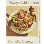 Cover of Always Add Lemon: Recipes You Want to Cook - Danielle Alvarez featuring a fresh salad with greens and cured meat on a ceramic plate, styled with kitchen decor and warm lighting from Knotty and Board. 1