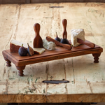 Wooden Serving Riser 18 X 8 X 3 displaying an assortment of cheeses and fresh figs with wooden spreaders on a rustic wooden table, ideal for kitchen and dining decor. 1