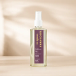 Clear glass spray bottle of Rockaway Folklore Fig Room Spray with purple label, displayed on a neutral background, perfect for decor and gifting at Knotty and Board. 1