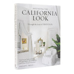 Inventing the California Look book cover featuring a bright, airy interior with white furniture, soft drapery, green plants, and a minimalist design aesthetic. 1
