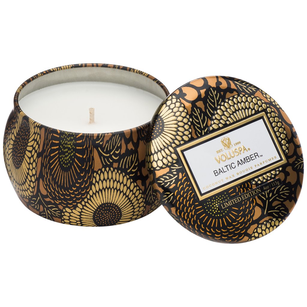Voluspa Baltic Amber Mini Tin Candle,4 oz., in a decorative black and gold floral tin, perfect for adding a warm touch to kitchen, dining, or living spaces with Knotty and Board.