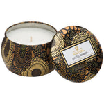 Voluspa Baltic Amber Mini Tin Candle,4 oz., in a decorative black and gold floral tin, perfect for adding a warm touch to kitchen, dining, or living spaces with Knotty and Board. 1