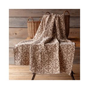 Millet Botanical Print Cotton Throw, 50 X 60 in., displayed draped over a rustic wooden bench with woven baskets in the background, adding cozy decor charm from Knotty and Board.