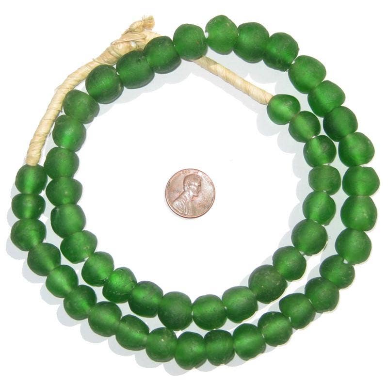 Green Recycled Glass Beads, 14 mm, arranged in a loose circle next to a penny for size comparison, perfect for unique jewelry or home decor from Knotty and Board.
