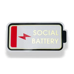 Funny Vinyl Sticker, Low Social Battery featuring a low red battery icon with gold text on white background, a humorous decor gift perfect for Knotty and Board fans. 1