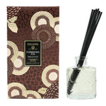 Voluspa Forbidden Fig Reed Diffuser, 3.4 oz with decorative brown and cream floral packaging and textured glass bottle with black reeds, perfect for gifting and home decor from Knotty and Board. 1
