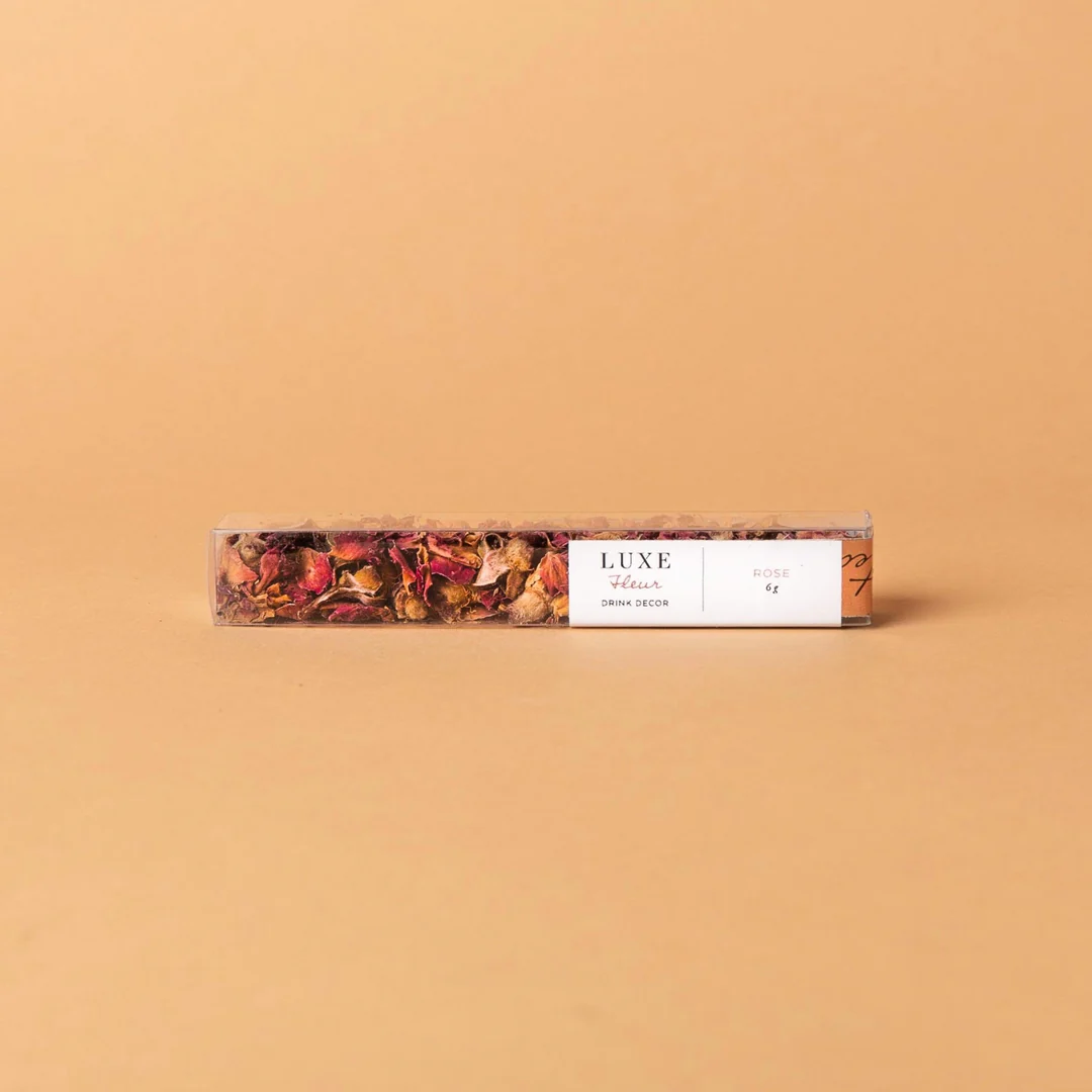 Teaspressa Luxe Mini Toppings, Rose Petals in a clear rectangular container with dried rose petals inside, styled on a neutral beige background for kitchen or dining decor.
