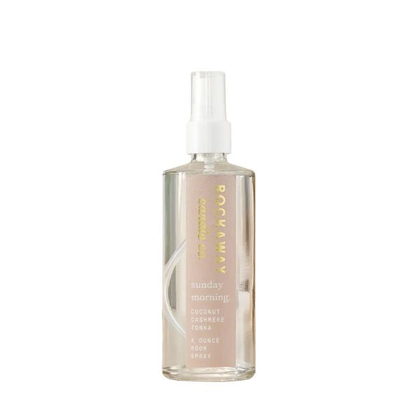 Clear spray bottle of Rockaway Sunday Morning Room Spray with white pump, featuring subtle gold and cream text, perfect for home decor and gifting.