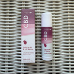 Yuzu Hemp Skin & Lip Balm, 50 mg, Lychee Blossom in white and purple packaging on woven surface, perfect for decor or gifts from Knotty and Board. 1