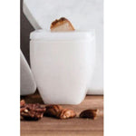 Close-up of the Precious Elements Vessel, 3 X 4 in., a white square-shaped decorative container holding a wooden accent, displayed on a wooden surface with natural decor elements, perfect for gifts and kitchen decor from Knotty and Board. Every Room Needs A Little Knotty and Board. 1