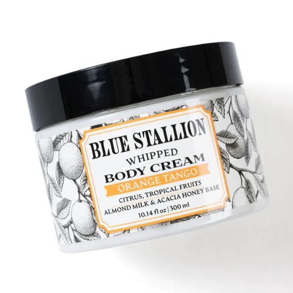 Jar of Blue Stallion Whipped Body Cream, Orange Tango with black lid and decorative citrus fruit and leaf design, a curated gift from Knotty and Board for decor and personal care.