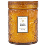 Voluspa Baltic Amber Small Jar Candle, 5.5oz, in an amber embossed glass jar, perfect for home decor, gifts, kitchen ambiance, and entertaining from Knotty and Board. 1