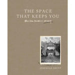Cover of The Space That Keeps You: Jeremiah Brent book featuring a minimalist design with beige background and a black and white photo of an outdoor stone pathway and archway, perfect for home decor inspiration from Knotty and Board, emphasizing cozy and curated living spaces. 1