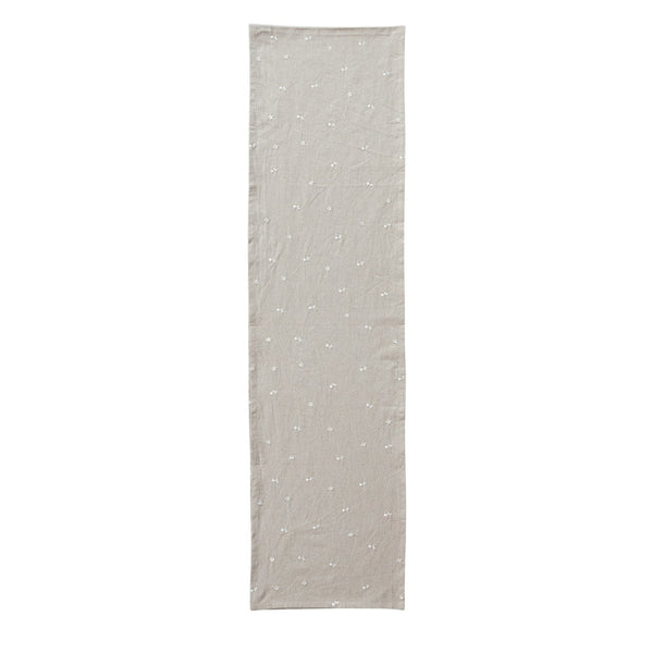Table Runner w/ Embroidered Flowers, 108" features delicate white floral embroidery on a neutral beige fabric, perfect for adding subtle decor to dining or kitchen spaces.