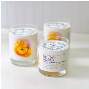 Just Bee Golden Amber Candle, 7 oz in clear glass jars with white wax and amber floral design, perfect for home decor and thoughtful gifts by Knotty and Board.